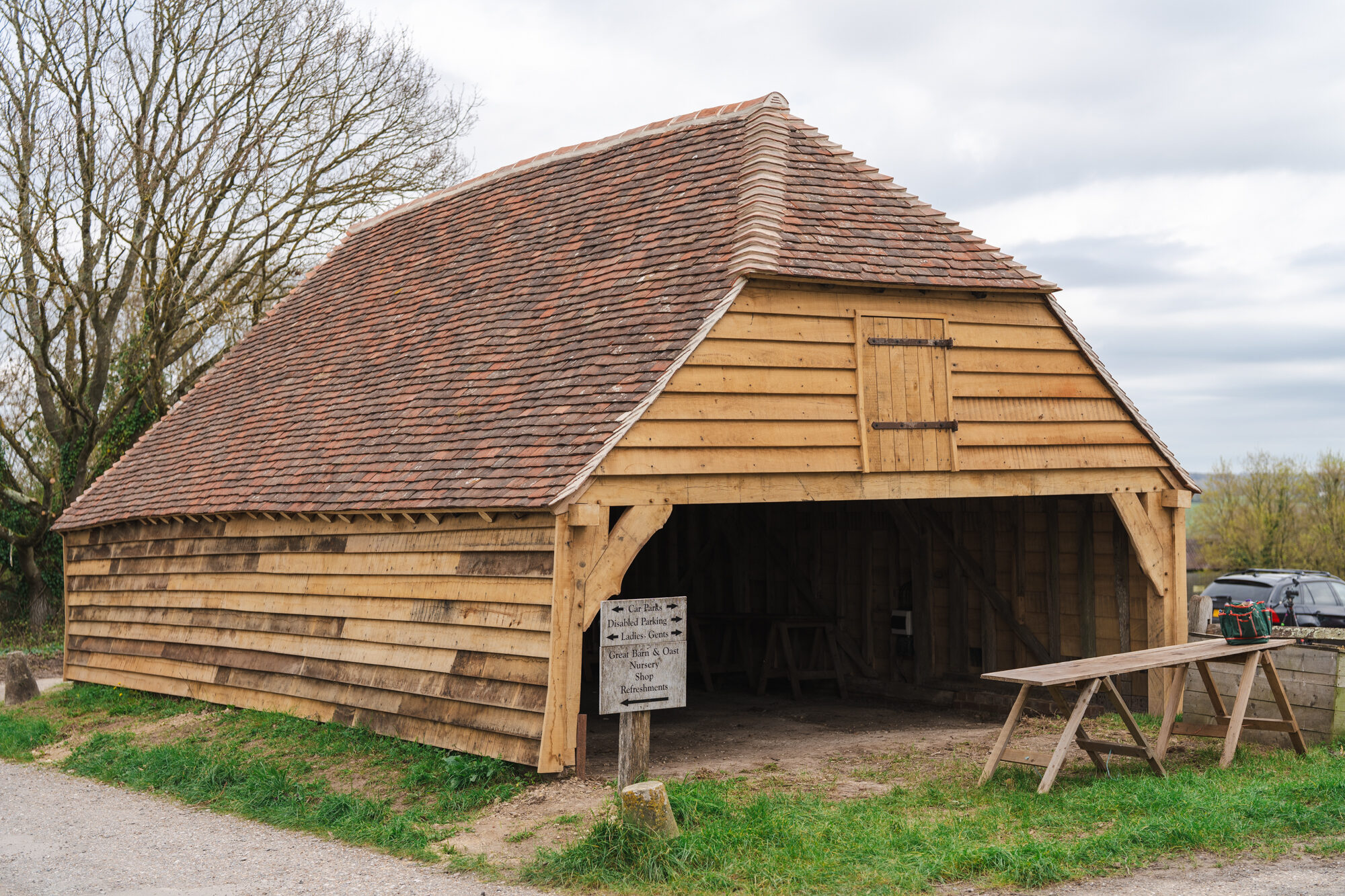 Restored oak-framed cart shed at Great Dixter